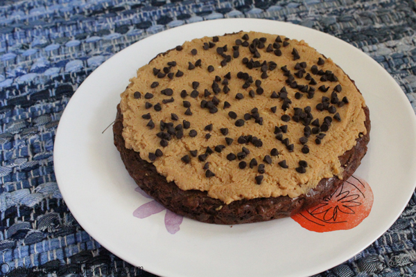 A 9-inch round chocolate brownie frosted with peanut butter cream cheese and sprinkled with chocolate chips.