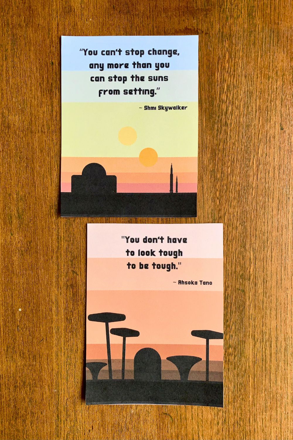 Two quotes against warm landscape backgrounds. The first is Shmi Skywalker saying, "You can't stop change, any more than you can stop the suns from setting." The second is Ahsoka Tano saying, "You don't have to look tough to be tough."