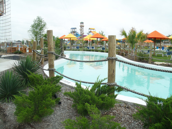 a lazy river winds around covered picnic areas at Splash Dazy, tall slides can be seen at the back