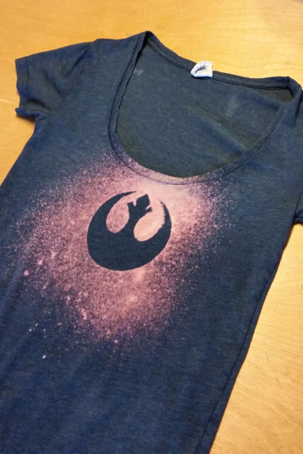 A pink and blue DIY bleach shirt with the Star Wars rebels logo.