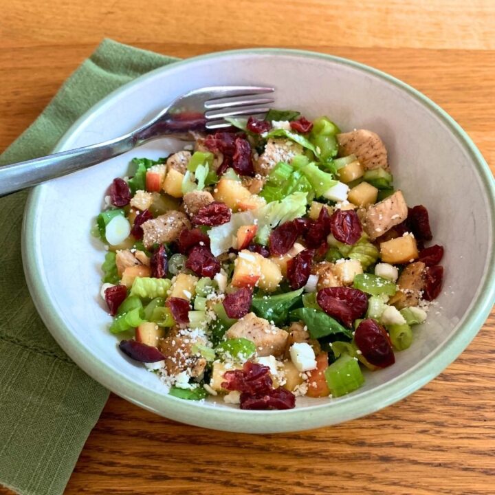 Harvest salad with chicken, lettuce, apples, celery, and feta cheese.