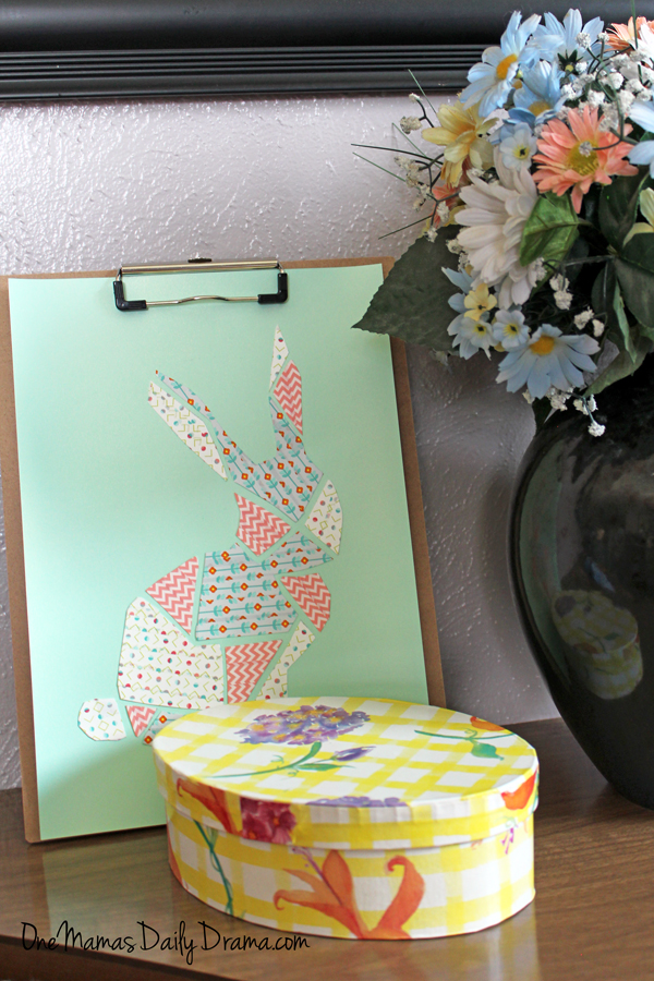 Artwork displayed on a clipboard sitting on a table.