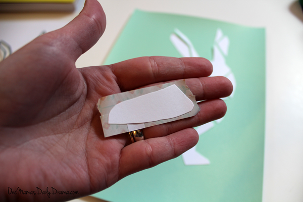 Hand holding washi tape attached to a piece of the bunny template.
