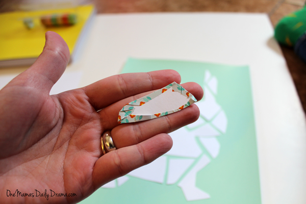 Hang folding the edges of the washi tape over the paper piece.