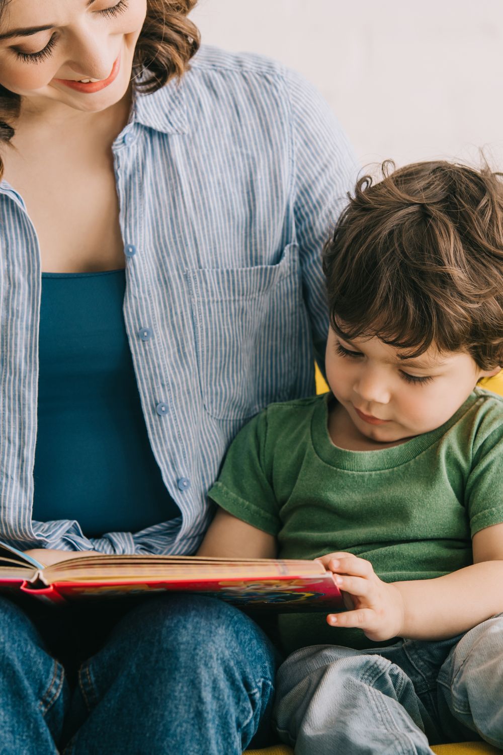 A mother reading a book with her child.