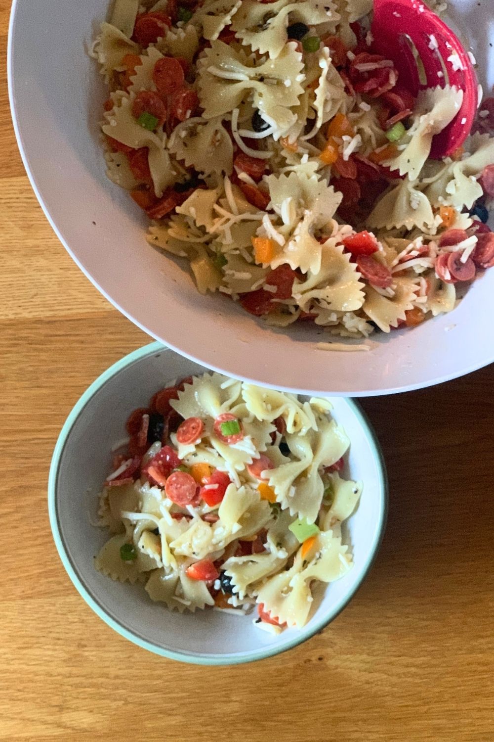 A filled bowl beside a serving dish.