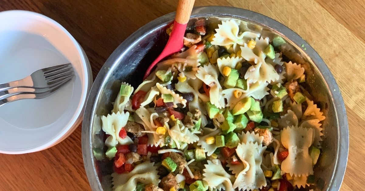 Southwest pasta salad with chicken, avocado, beans, and corn.
