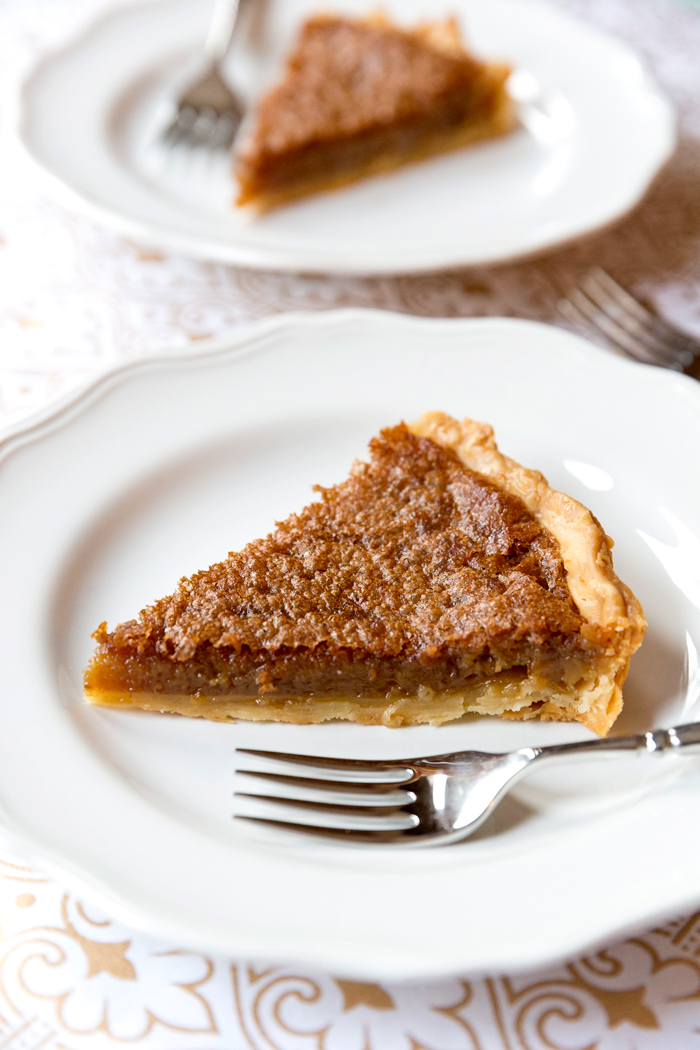 Slice of Southern Brown Sugar Pie on a white plate from Pizzazzerie.