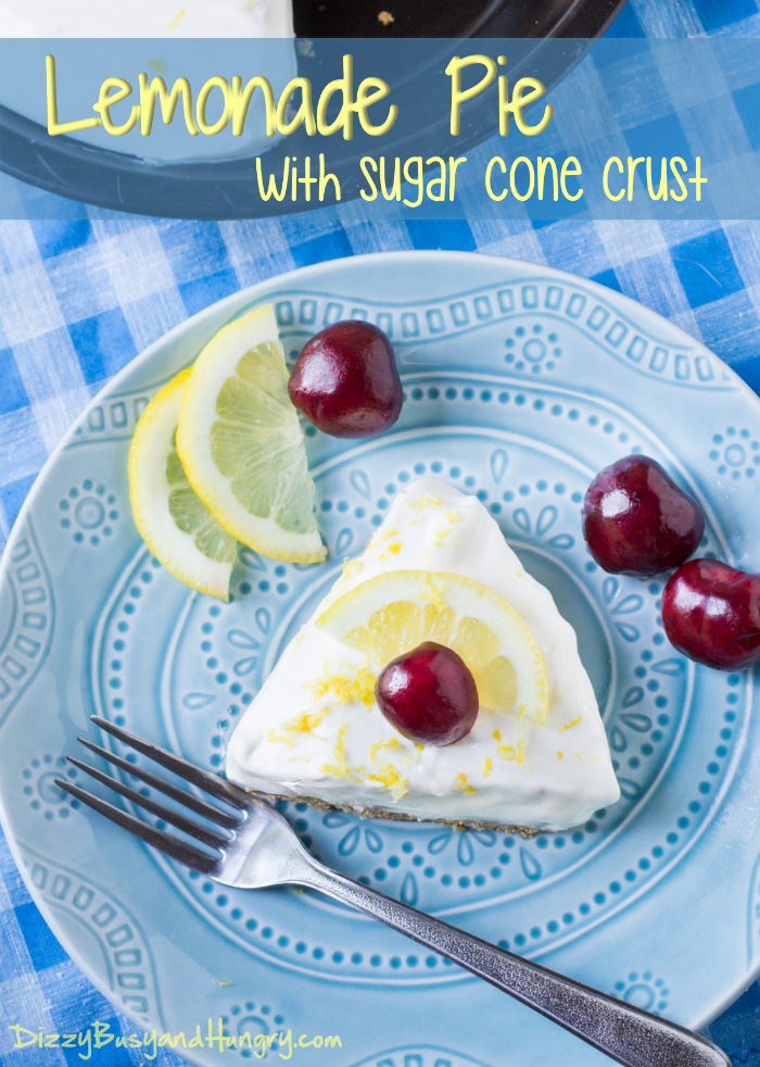 White Lemonade Pie with Sugar Cone Crust topped with a slice of lemon and a cherry from Dizzy Busy and Hungry.