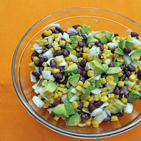 A bowl of black bean corn salad with avocado.