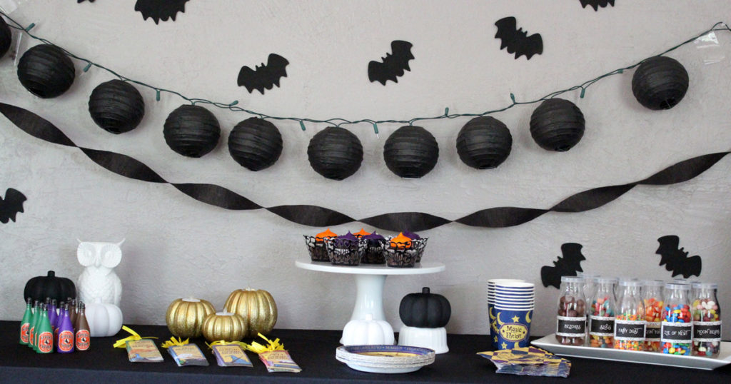 Magical Halloween party theme | Classy black and white pumpkins mixed with wizard potions and tableware make for a fun evening for kids and adults.