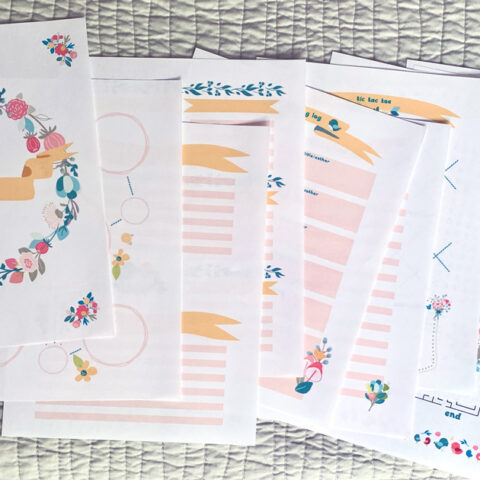 A dozen spring activity pages spread across a blanket.