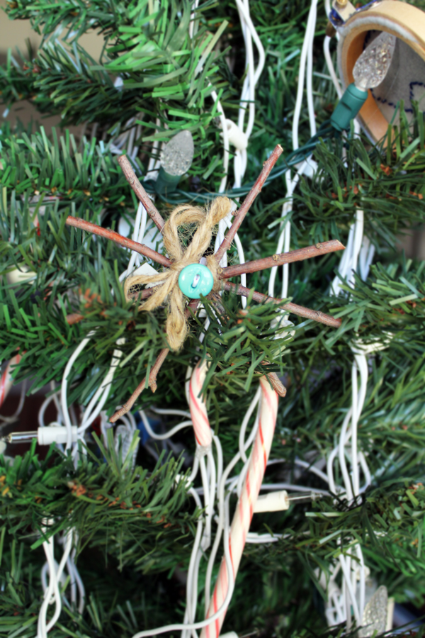 snowflake ornament made from twigs tied together with jute
