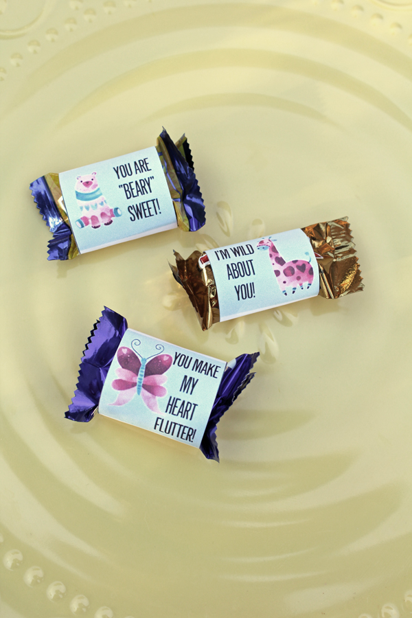 three wrapped candies with tags that say "you are beary sweet," "I'm wild about you," and "you make my heart flutter"