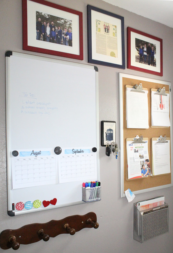 A more organized entryway with tidy bulletin boards on a gray wall.