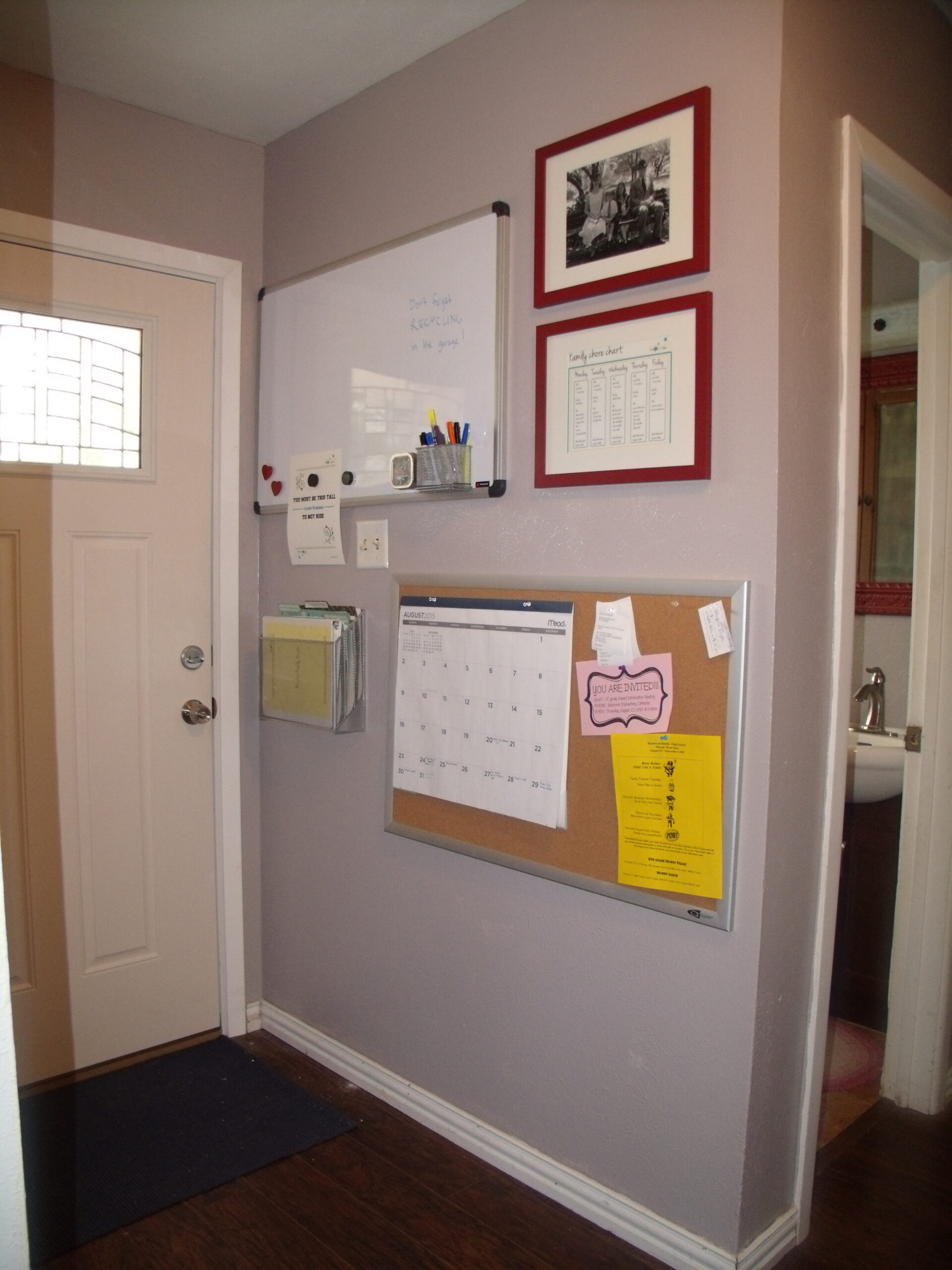 The entryway before was gray and cluttered with bulletin boards and papers on the wall.