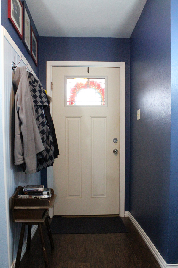 An organize entryway makeover includes space for coats to hang from hooks on one wall.