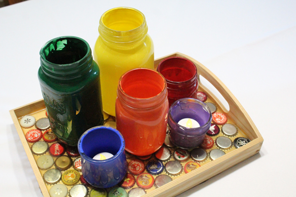 painted jars on a wooden tray