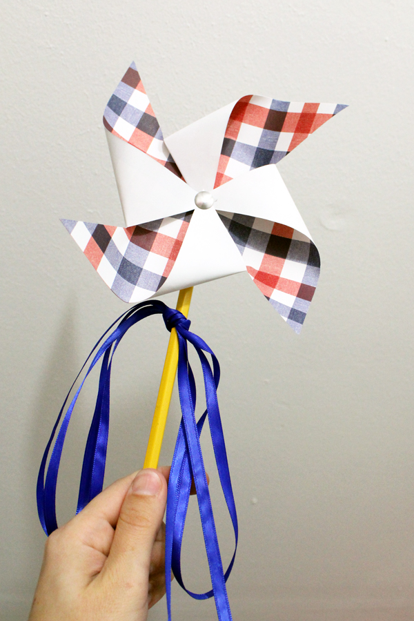 hand holding a paper pinwheel
