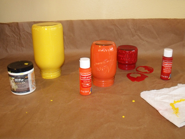 painted glass jars upside down on brown paper