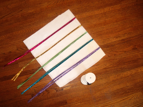 5 ribbon colors stitched to a white rectangle of fleece folded in half