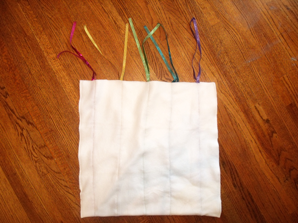 pillow inside out with ribbon ends hanging out of the top