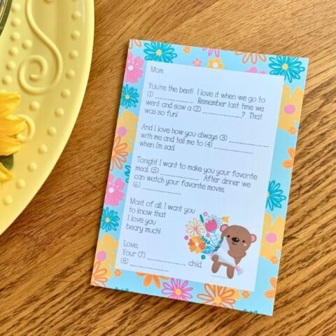 Printable Mad Libs Mother's Day card with a short letter with fill-in-the-blank lines beside a cute bear holding flowers.
