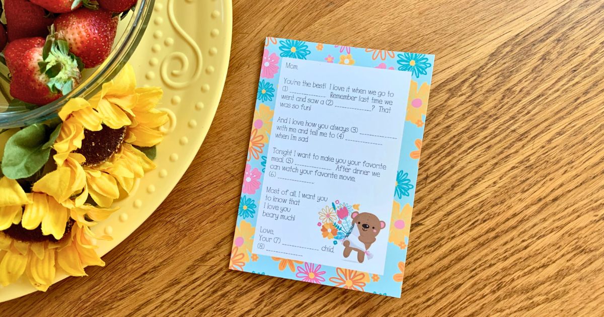 Printable Mad Libs Mother's Day card with a short letter with fill-in-the-blank lines beside a cute bear holding flowers.