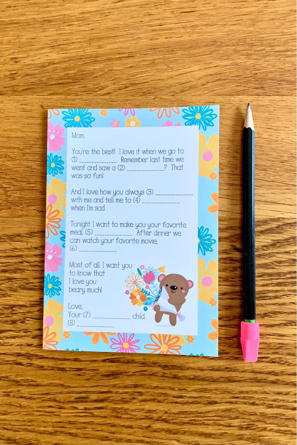 Folded Mother's Day card with a letter and blank lines beside a cute bear holding flowers.