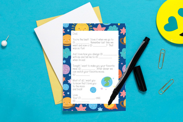 Father's Day card and a pen on a blue table