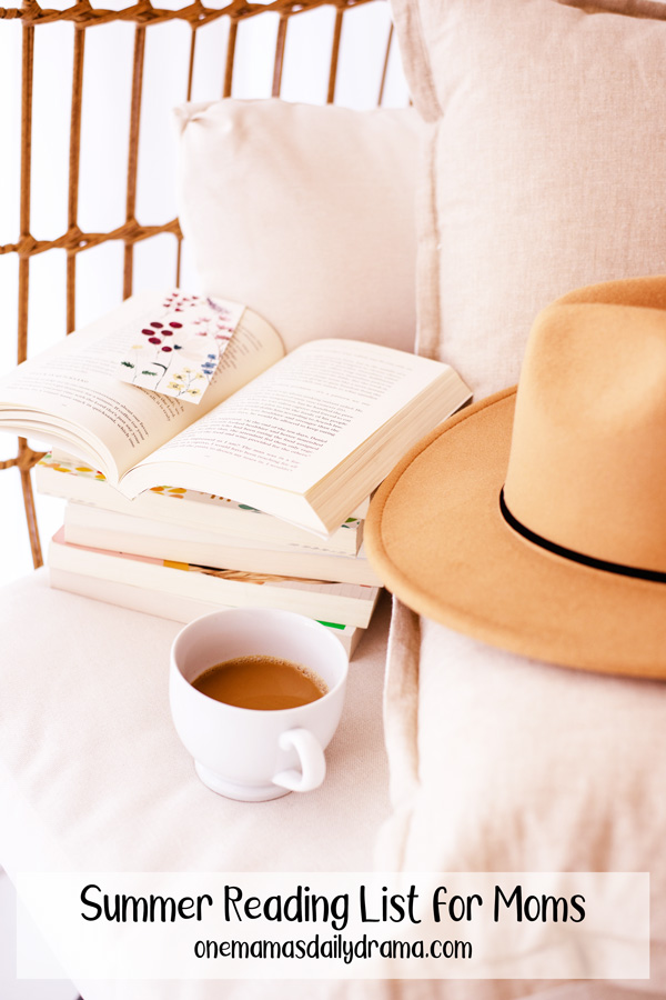 stack of paperback books on a sofa beside a cup of tea and a text overlay that says "summer reading list for moms"