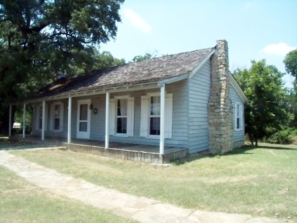 VanZandt cottage sits in a green park area
