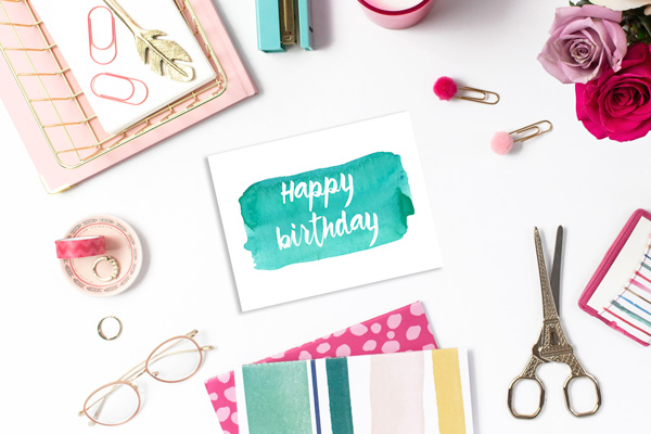 green watercolor card that reads "happy birthday" in white text