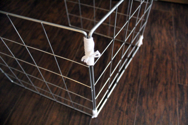 white yarn holding a metal grid together aesthetically