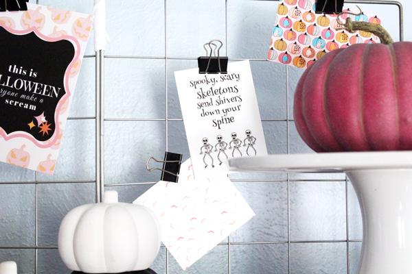 skeleton and pumpkin printables clipped to a metal grid
