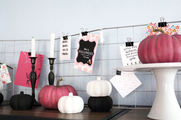 shelf display with pumpkins, candles, and printable art