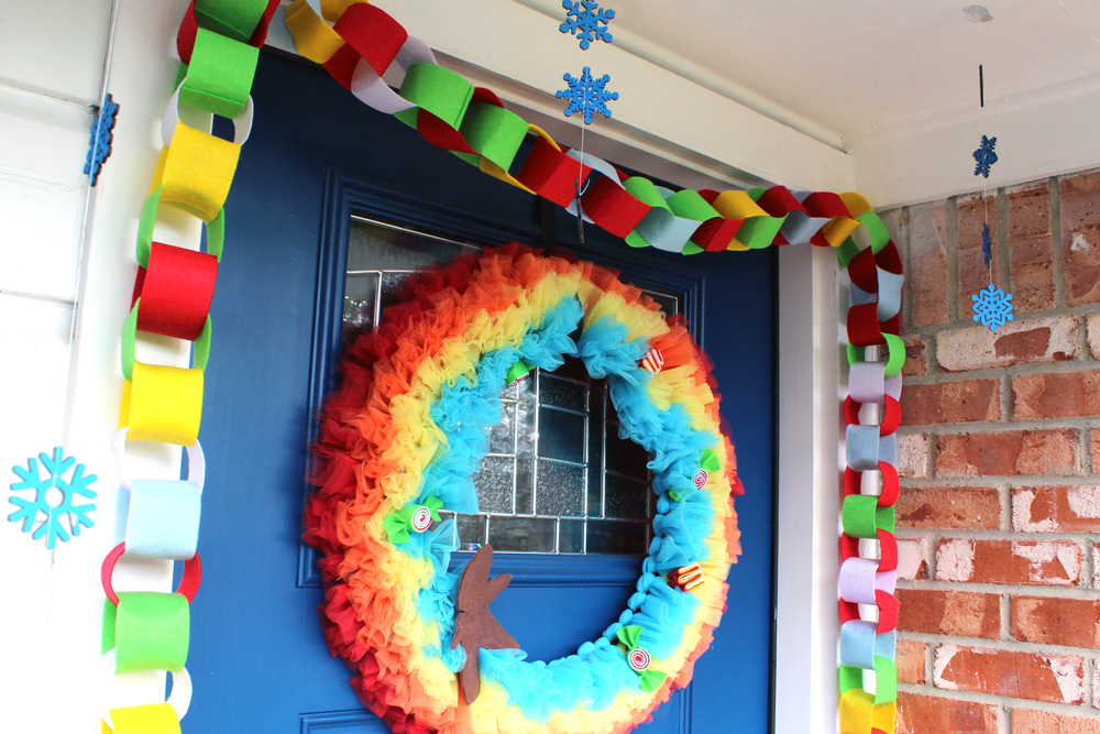 a felt chain garland around the top and sides of a blue front door