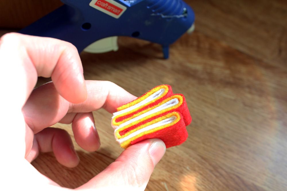 hand folding felt into a ribbon candy shape