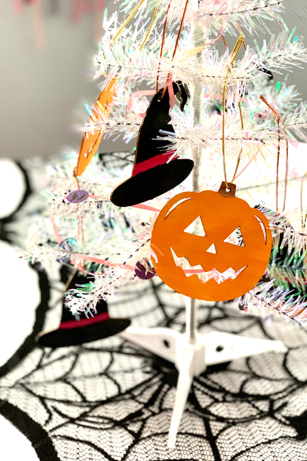 Wooden jack o'lantern Halloween ornament painted orange with a brown stem.