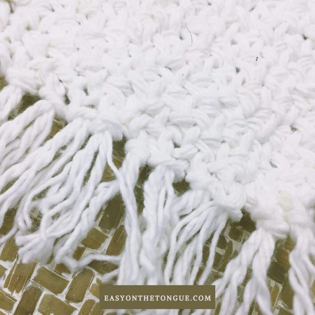 White coaster with tassels from Easy On the Tongue.