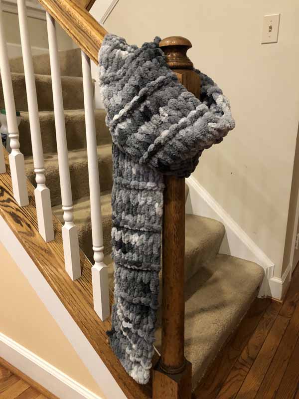 Gray finger knit scarf from Needlepointers.