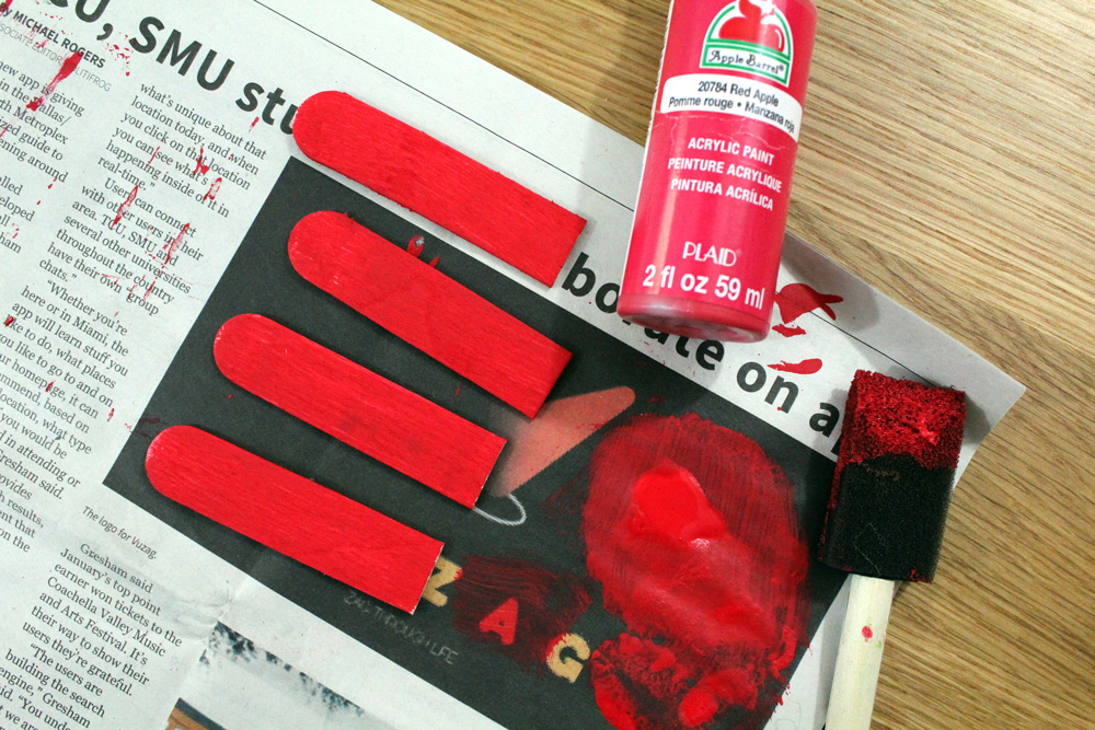 2 craft sticks cut in half and painted red.