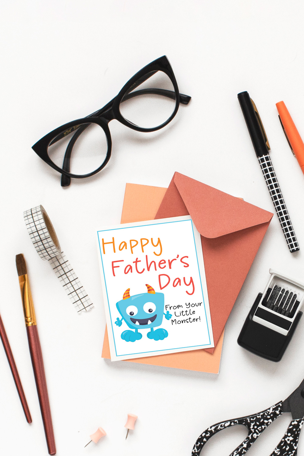 Blue, orange, and red greeting card illustration that reads "Happy Father's Day from your little monster!"