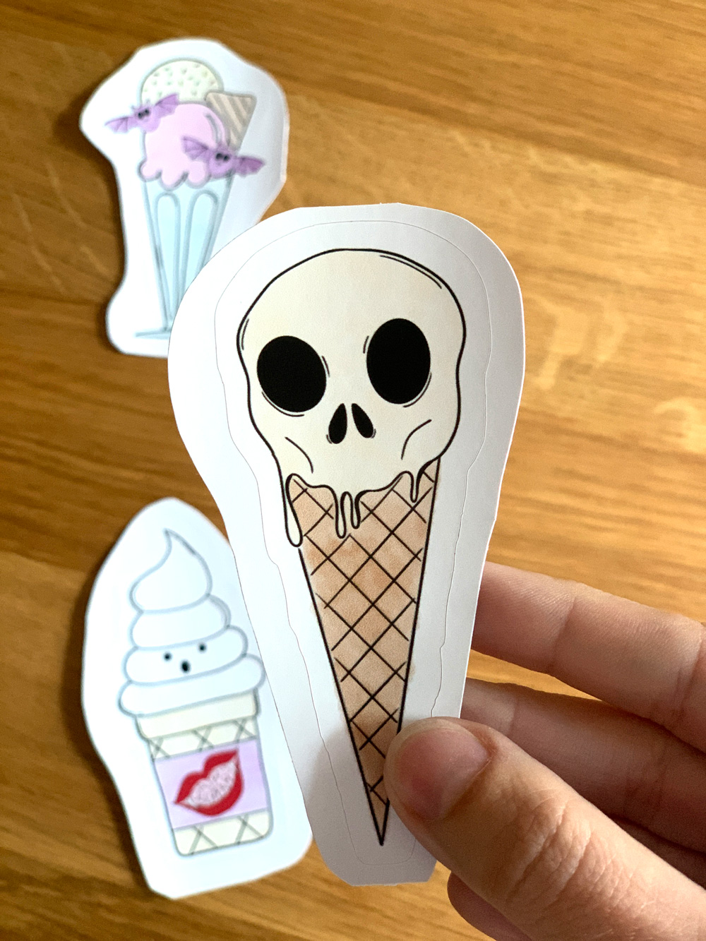Closeup of a melty ice cream cone skull sticker.