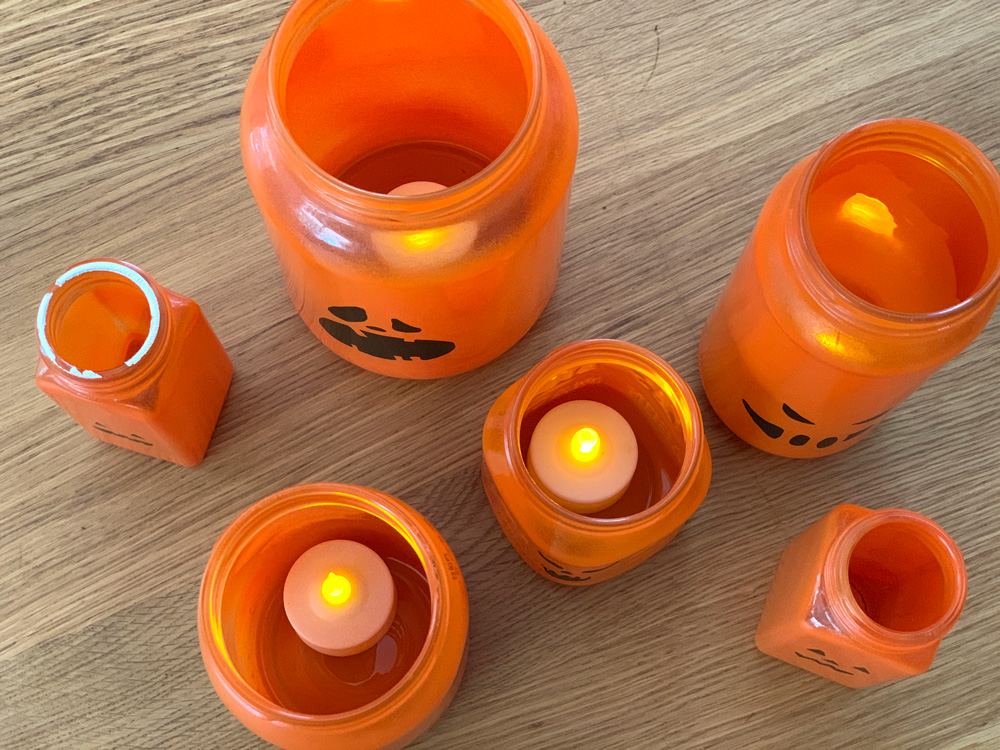 Glass jars with electric tea lights inside.