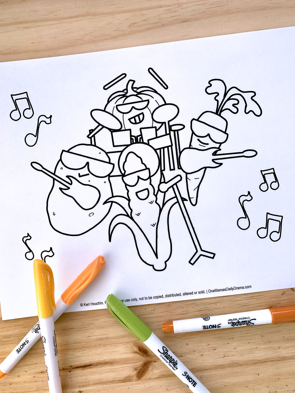 Coloring sheet of corn, carrot, pumpkin, and potato playing rock band instruments.
