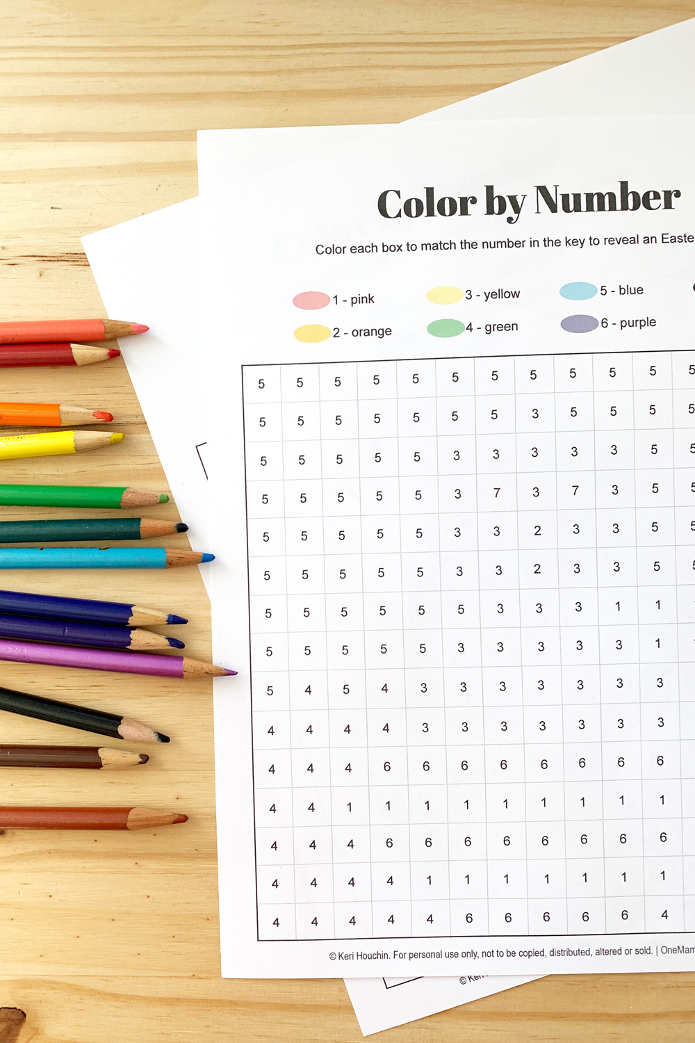Closeup of a color by number worksheet with a numeral in each box on a grid.