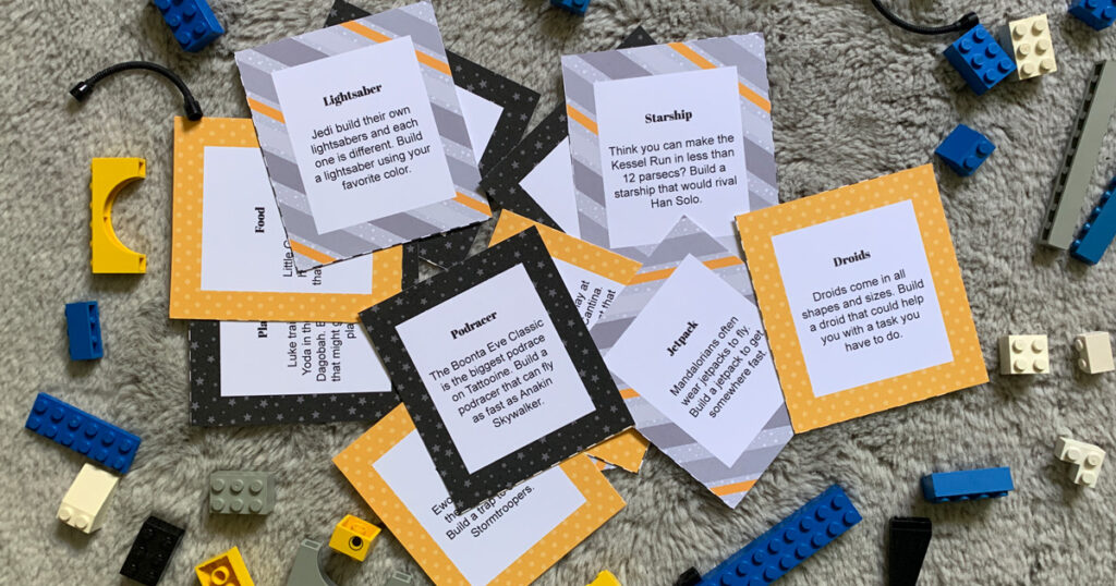 Star Wars LEGO building idea cards surrounded by assorted blue and yellow bricks.