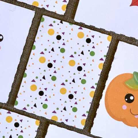 Printable Halloween memory game cards with a patterned back and a ghost and pumpkin turned over.