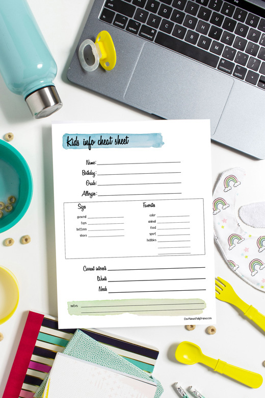 Kids' info cheat sheet with sizes and interests on a messy desk.